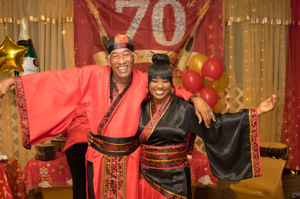 Guests celebrating a 70th birthday in themed attire