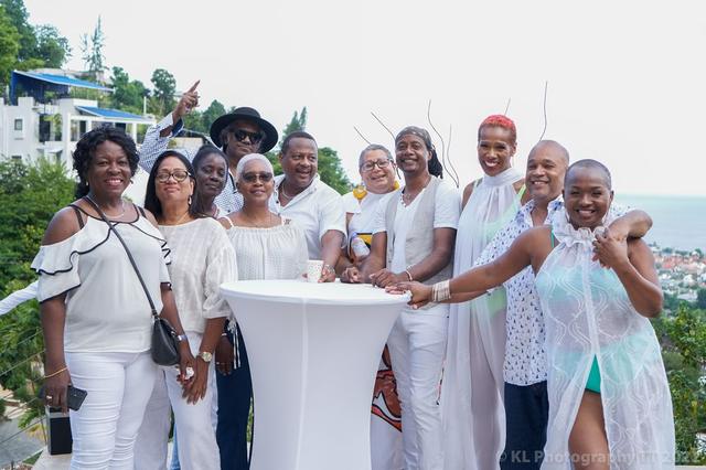 Friends gathered for a garden party in white attire