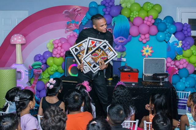 Magician entertaining children at a birthday party