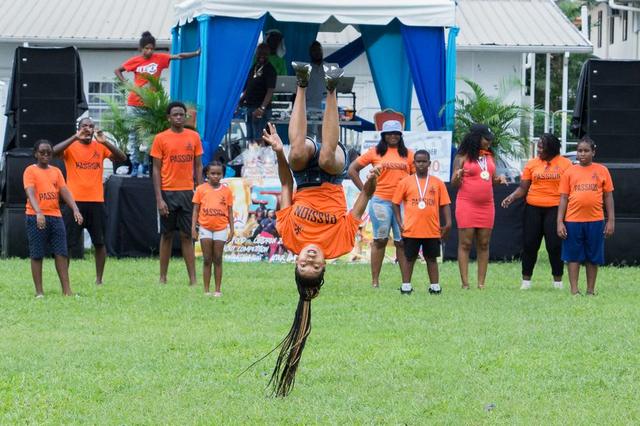 Performer mid-flip at a community sports day