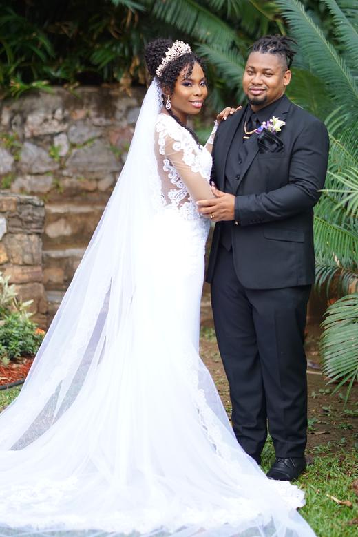 Bride and groom portrait in a lush garden