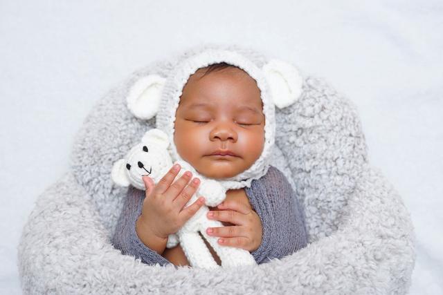 Sleeping newborn portrait in a knit bonnet
